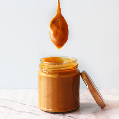 Salted Caramel Sauce in a jar with spoon dipped in, 150 g